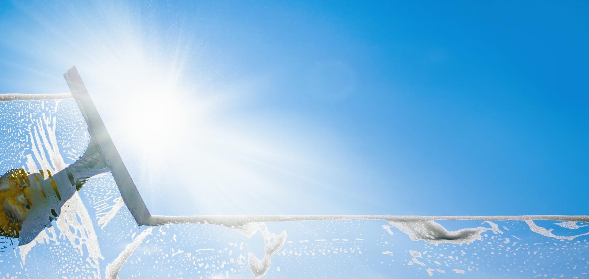 Window Cleaning 6 AustClean professional window cleaner using squeegee – expert window cleaning services delivering streak-free crystal clear glass Australia.