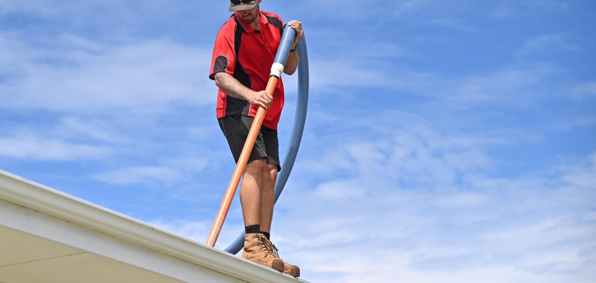 Roof Cleaning 5 AustClean professional roof cleaner performing gutter cleaning and roof maintenance – expert roof cleaning services with industrial vacuum equipment Australia.