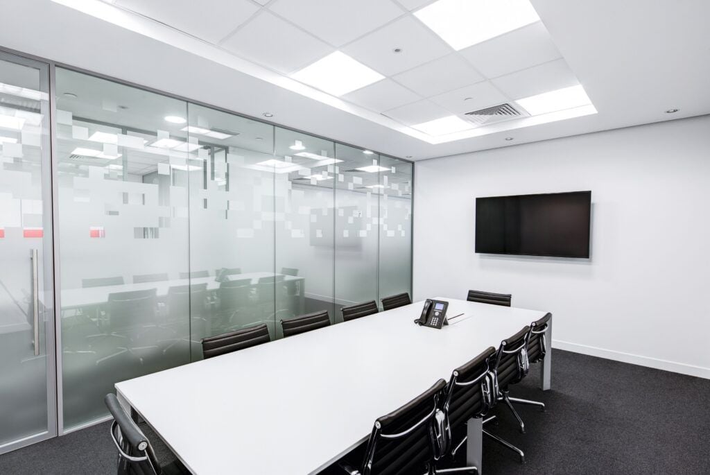 5 ways to keep your office looking fresh 1 AustClean professional office cleaning services – pristine modern conference room with white table, black chairs, and glass walls showcasing spotless commercial cleaning results for Queensland businesses.