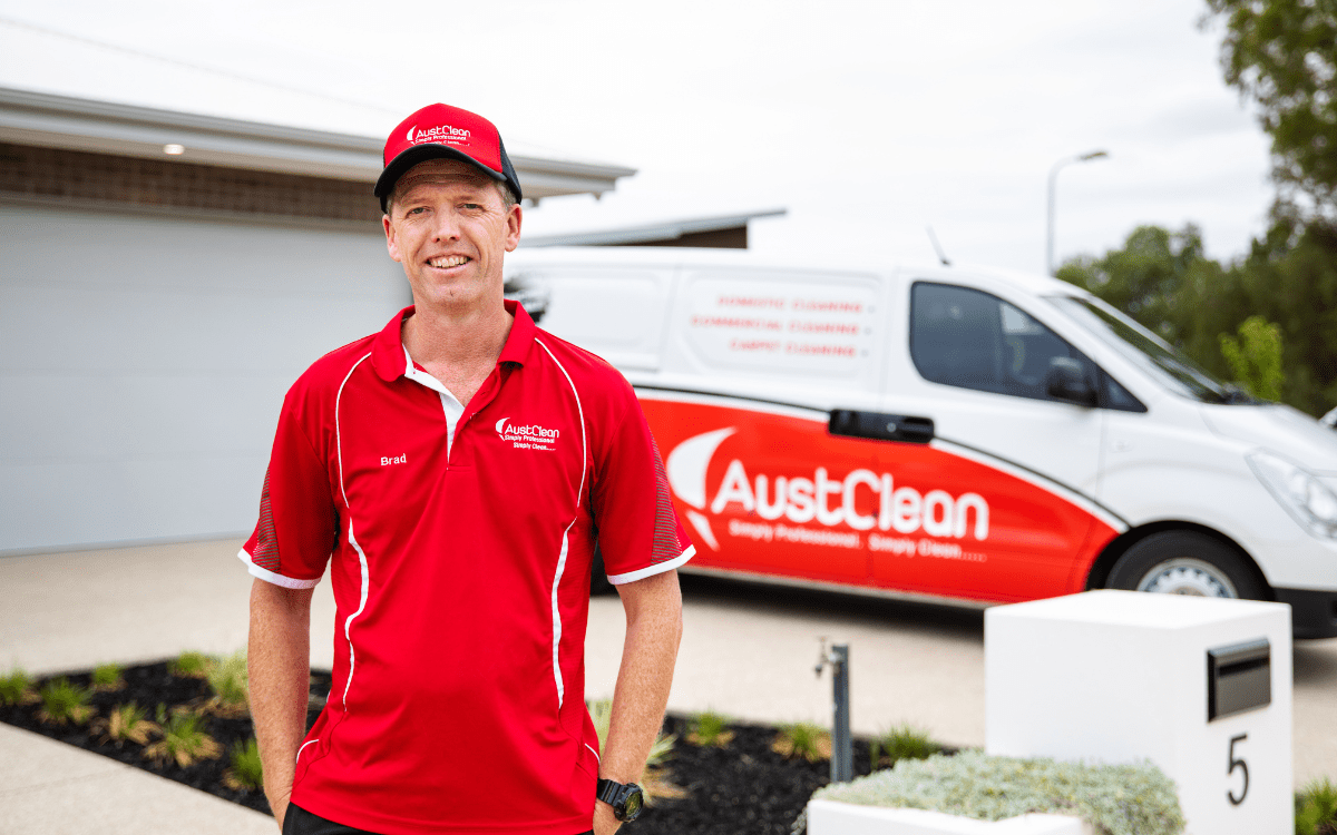 Franchise Opportunities 14 AustClean franchise owner with branded van and uniform – successful cleaning business franchise opportunity in Australia.